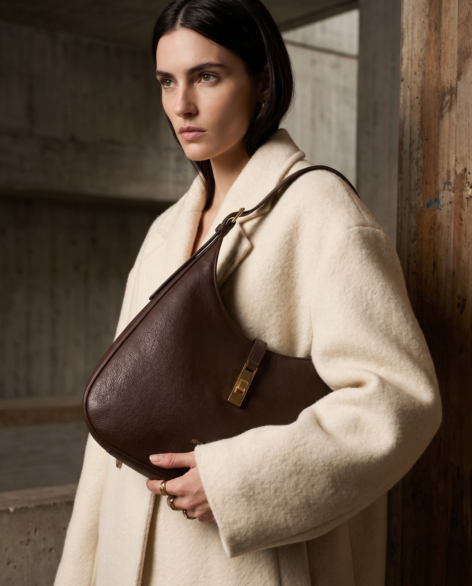 AI-generated: @recreateme-bag worn by dark haired, fair skinned female model. fashion photoshoot, texture clearly visible, medium close up. editorial.