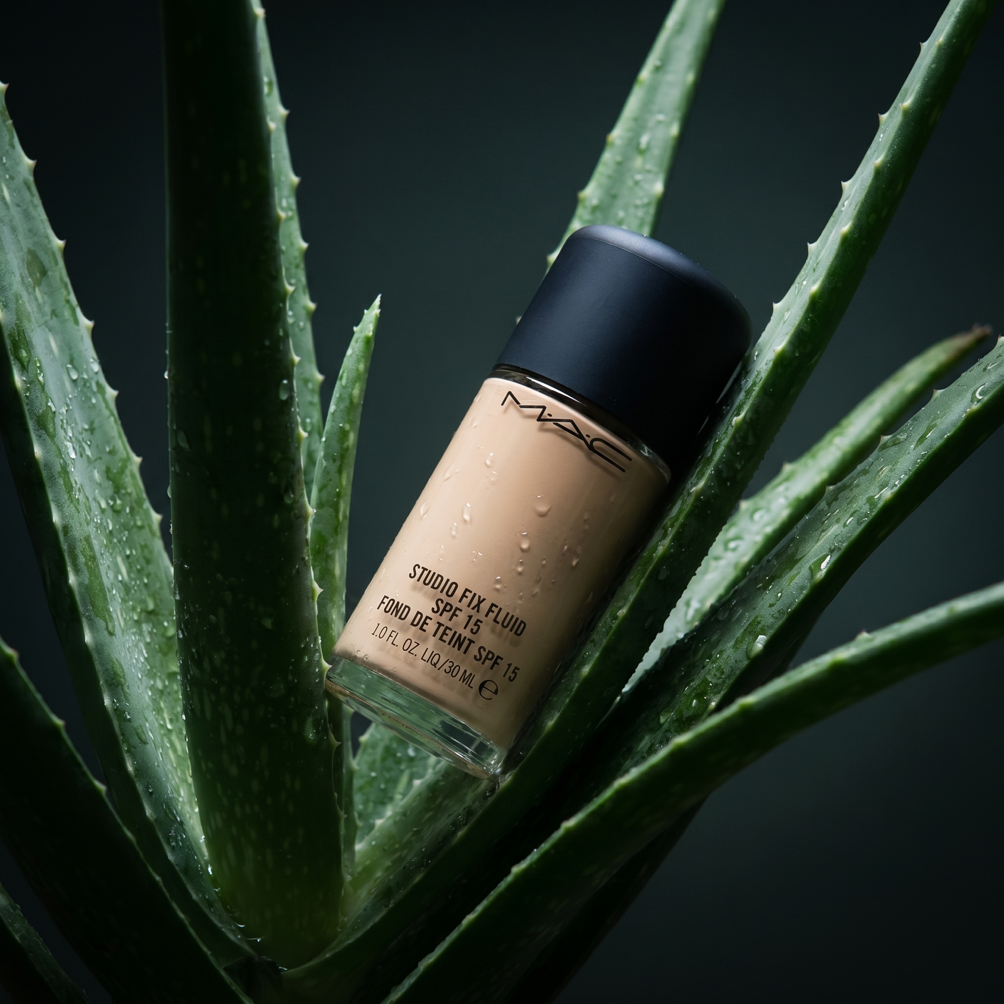 AI-generated: put the @mac studio fix fluid between the aloe vera leaves. editorial. high-end commercial photography.