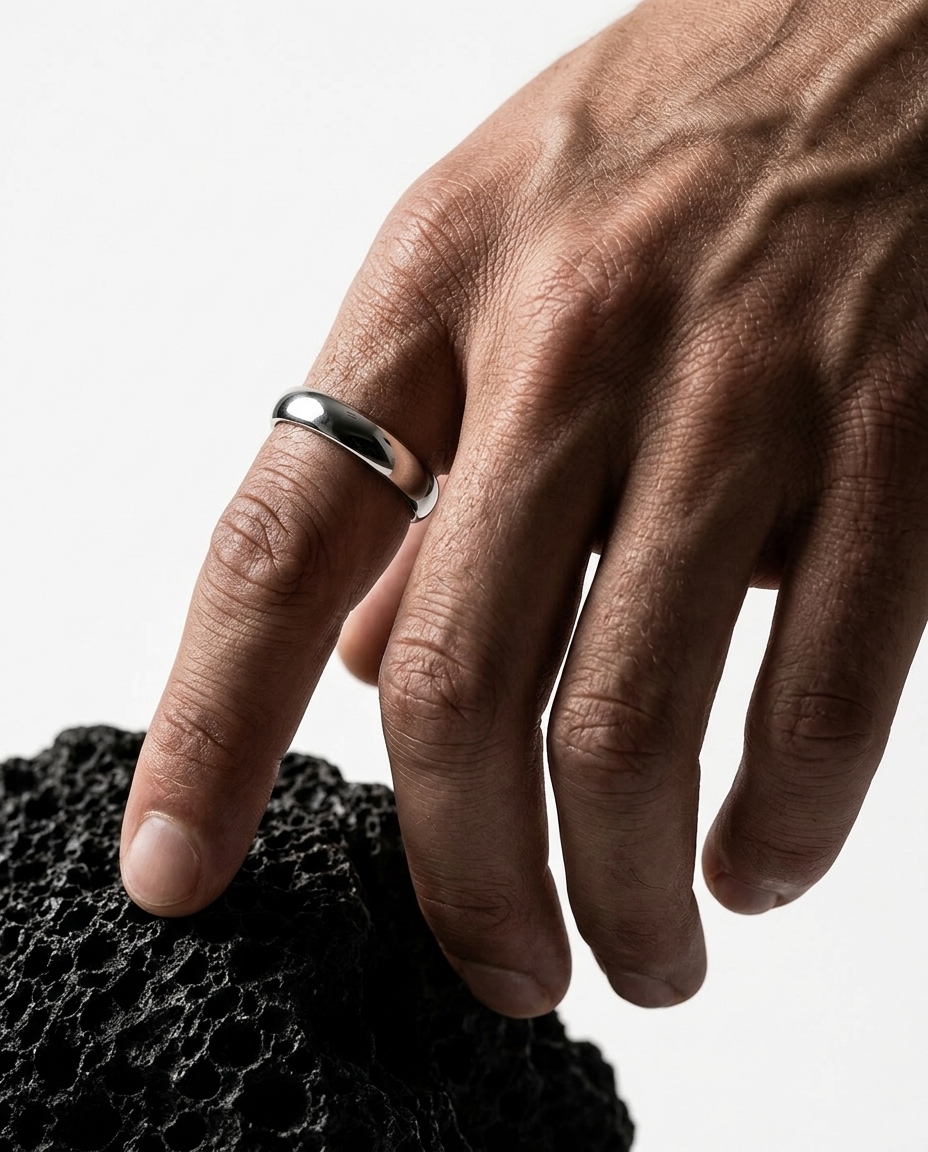 AI-generated: @recreateme-ring on a finger of male model. white background. editorial photoshoot.