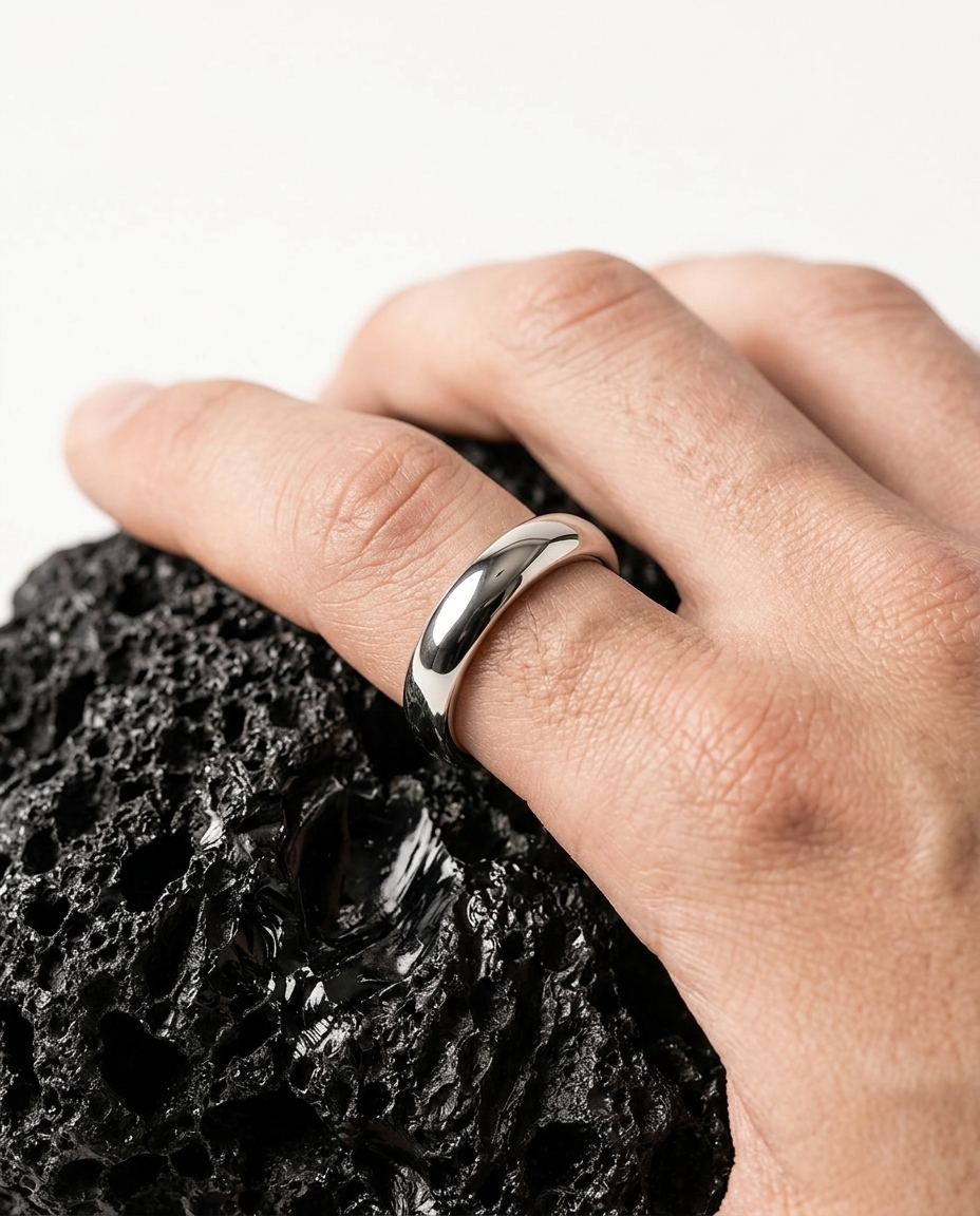 AI-generated: @recreateme-ring on a finger of male model. white background. editorial photoshoot.
