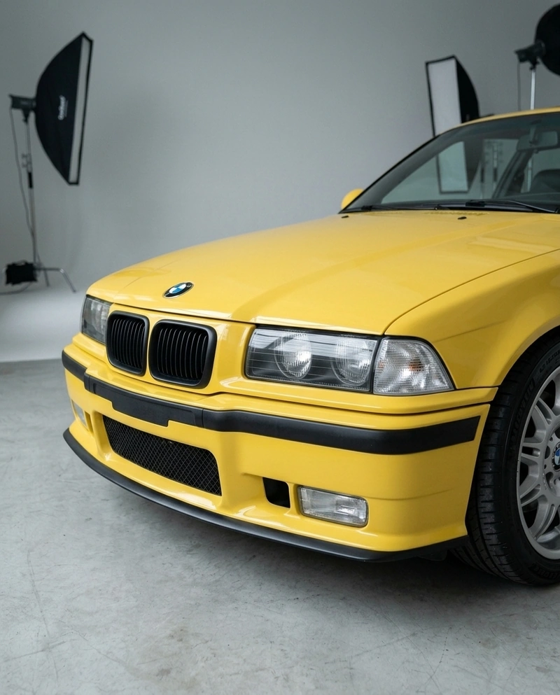 AI-generated: Using the studio setting from @studio city athletics hoodie, replace the subject with a 1996 BMW E36.