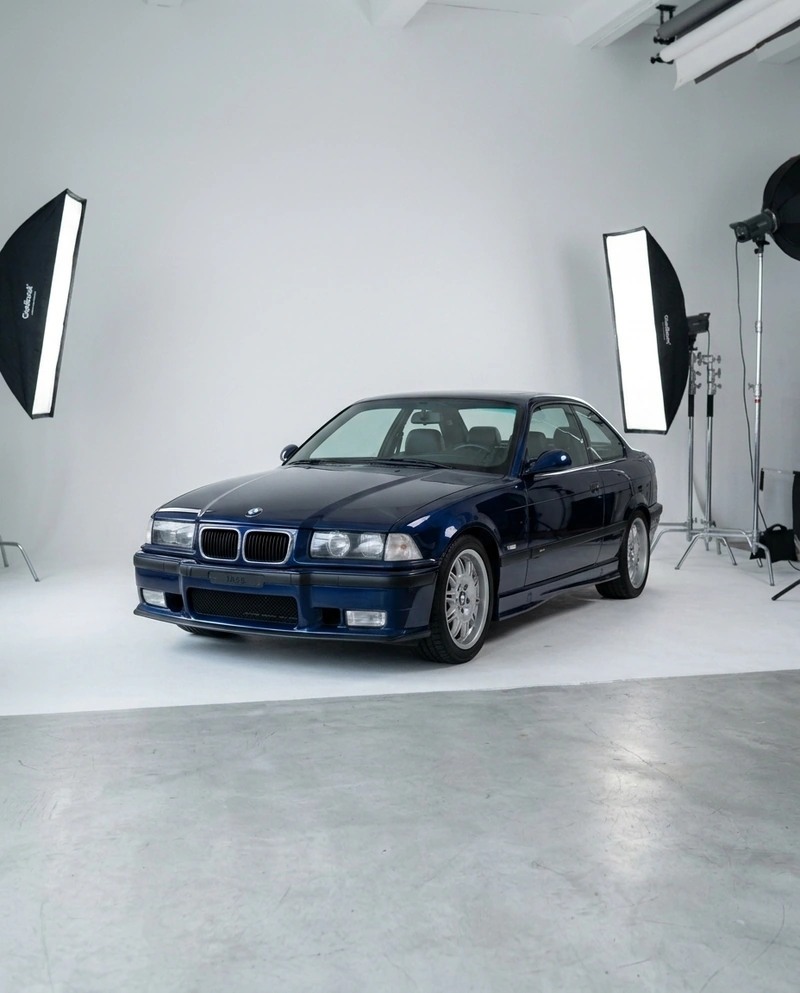 AI-generated: Using the studio setting from @studio city athletics hoodie, replace the subject with a 1996 BMW E36.